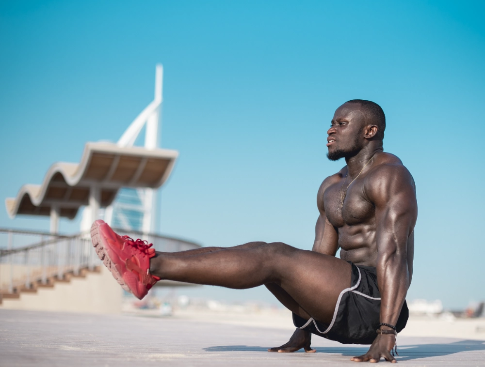 Fit man doing strength exercise on Jumeirah Beach Dubai