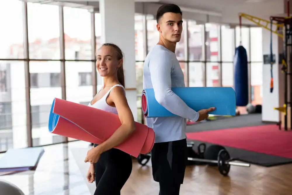 Couple in a gym, ready to start training.