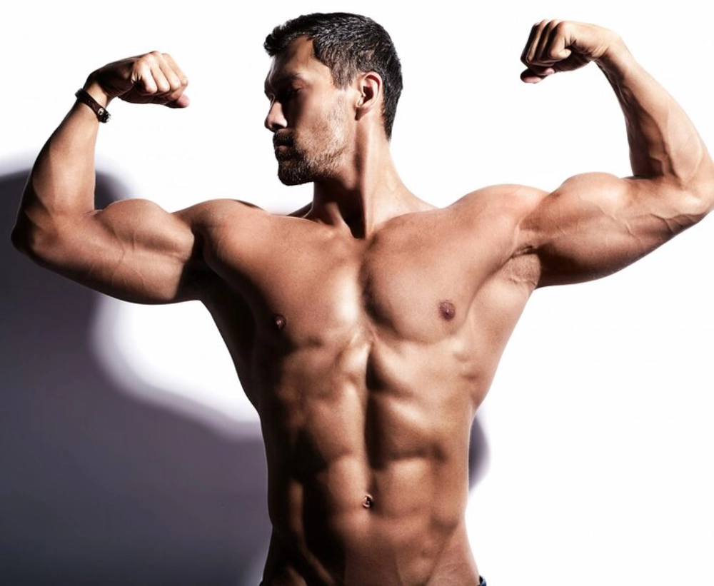 fit man with his arms raised posing