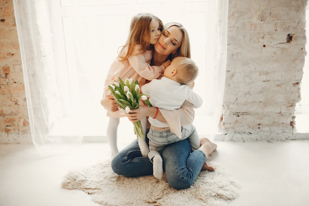 A happy mother with little children at home.