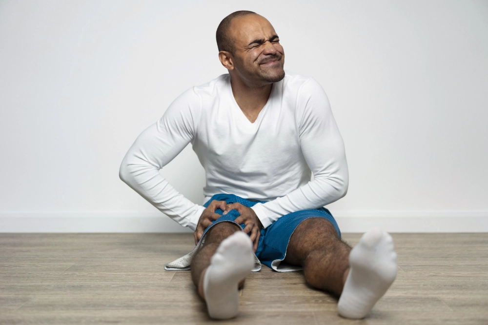 A person waking up with stiff in Dubai apartment post-leg day