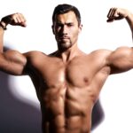 Man flexing front double biceps in gym, demonstrating exercises to increase testosterone naturally.