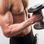 Personal Trainer Dubai doing cross body dumbbell hammer curls in Dubai