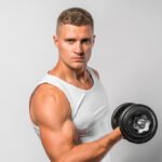 Fit athlete doing alternate bicep curl exercise