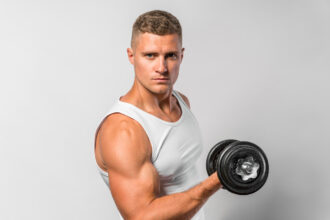 Fit athlete doing alternate bicep curl exercise
