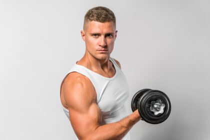Fit athlete doing alternate bicep curl exercise