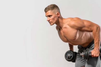 A fitness athlete doing dumbbell tricep kickback exercise