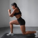 Fit girl doing front lunges exercise