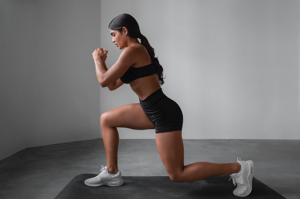 Fit girl doing front lunges exercise