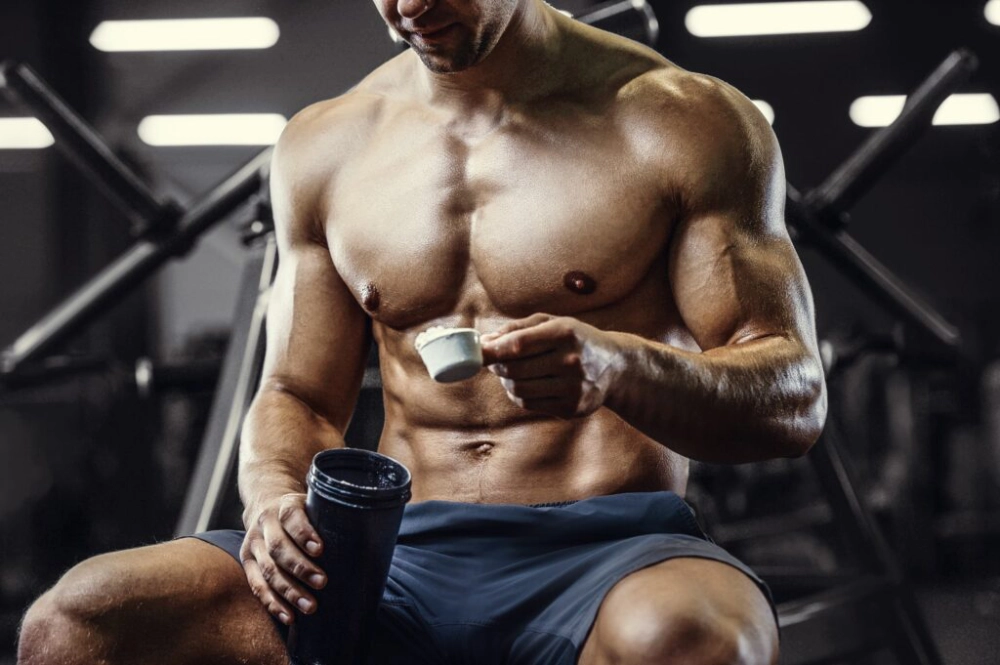 Fit Man mixing BCAA in the gym for maximum protein synthesis
