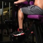 Bodybuilder doing a seated calves exercise