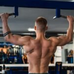 Fitness athlete doing pull ups in the gym