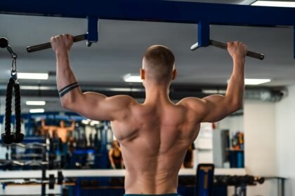 Fitness athlete doing pull ups in the gym