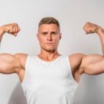 An athlete showing bicep muscles after a workout
