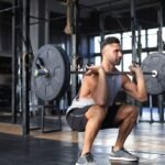 A fit man doing barbell front squats