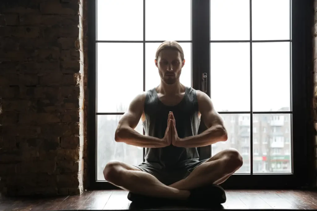 A healthy young sportsman meditating in a lotus pose