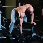 A man preparing start training one arm dumbbell row - back workout