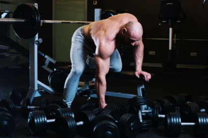 A man preparing start training one arm dumbbell row - back workout