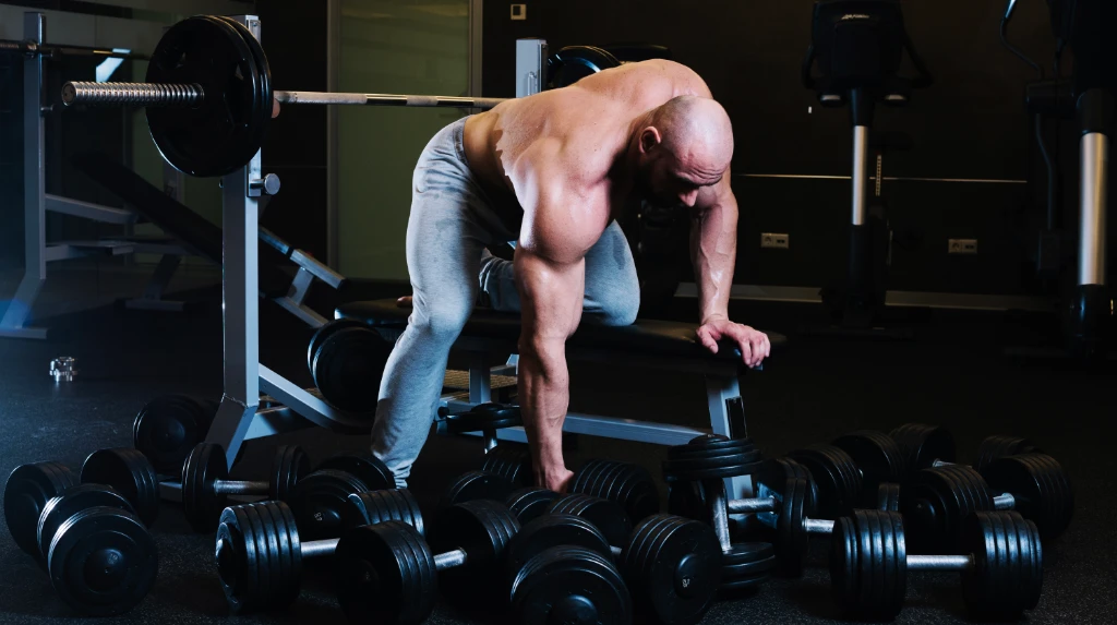 A man preparing start training one arm dumbbell row - back workout