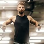 Fitness Athlete doing Chest Flys on a cable machine in Dubai Gym