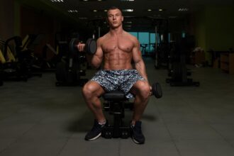 A fit Young man doing Incline Bench One Arm Bicep Curl