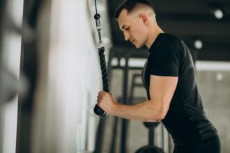 Young man demonstrating how to do a tricep extension