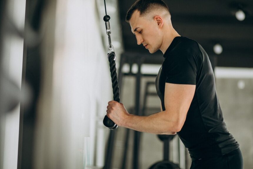Young man demonstrating how to do a tricep extension
