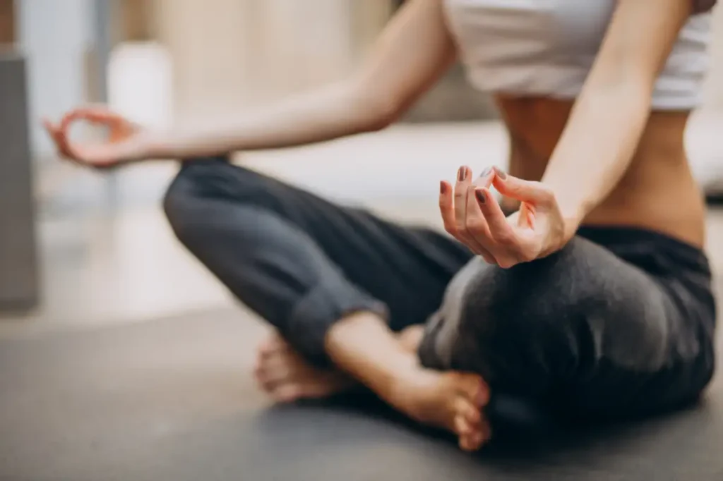 A young woman practicing yoga at home