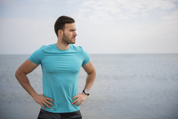 A confident, healthy man standing on a shoreline, looking out to sea with his hands on his waist, embodying vitality and a balanced lifestyle.