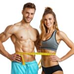 A determined man and woman, using a measuring tape to track their waistline as part of a successful, science-based fat loss journey.