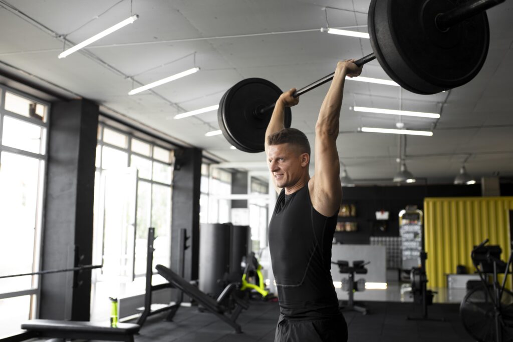 A powerful athlete completing a barbell overhead military press, showcasing strength and muscle engagement under load.